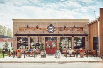 People sit on the patio in front of Eau Claire distillery in Diamond Valley.