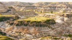 Person and their dog hiking in the badlands