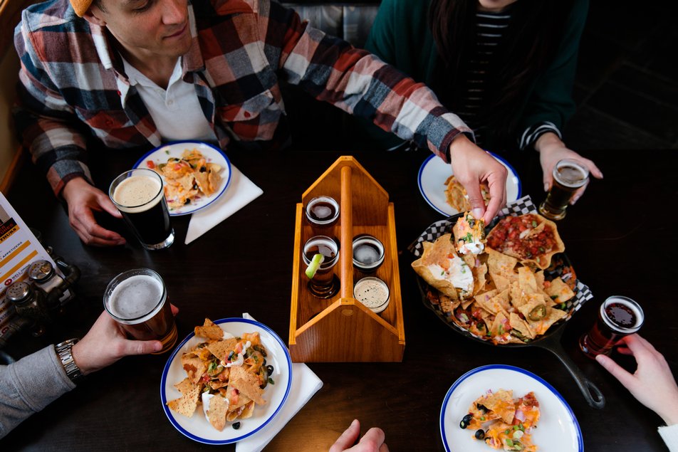 People enjoying craft beer and food at Jasper Brewing Company