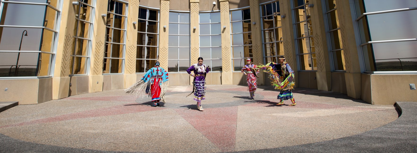 Siksika Blackfoot dancers in front of the Blackfoot Crossing Historical Park Interpretive Centre.