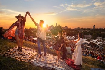 Friends dancing at dusk at the Edmonton Folk Festival