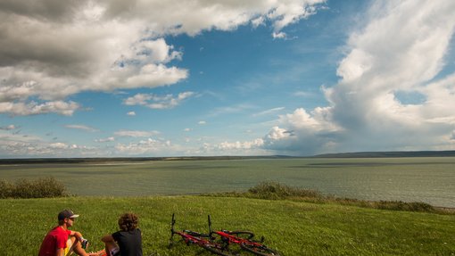 Two people having a picnic after riding bikes near Cold Lake