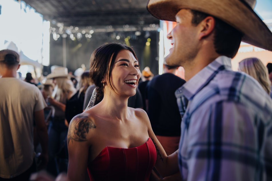 Couple dancing at Nashville North with people in the background.