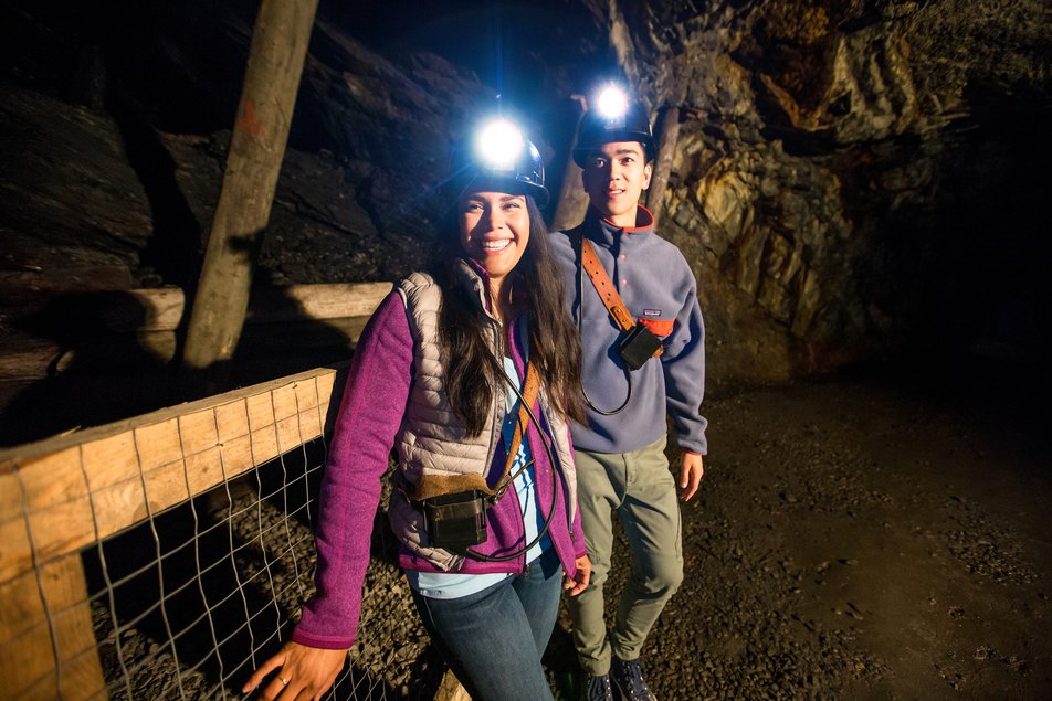 Guest with wearing headlamps on a mine tour.