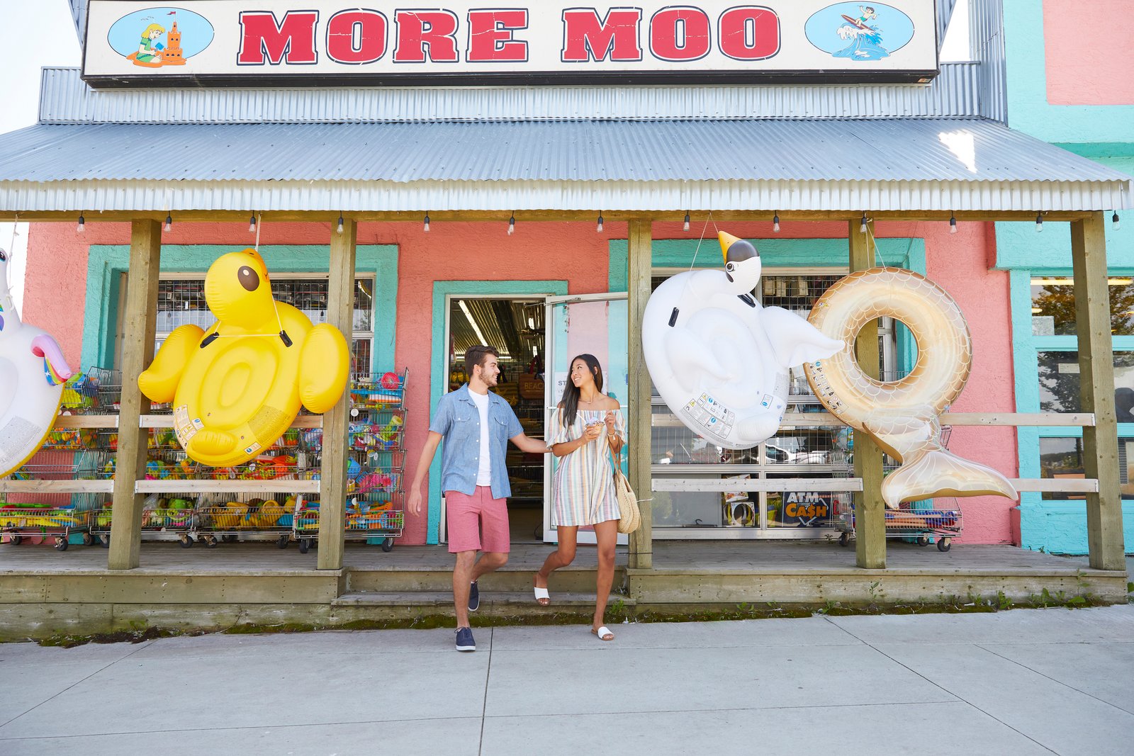 A couple walking out with of the More Moo ice cream shop in Sylvan Lake.