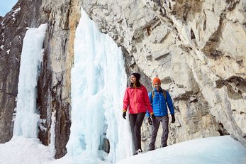 A couple ice hiking through Grotto Canyon near Canmore in Kananaskis Country.