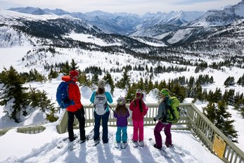 A family on a snowshoe tour to Sunshine Meadows in Banff National Park.