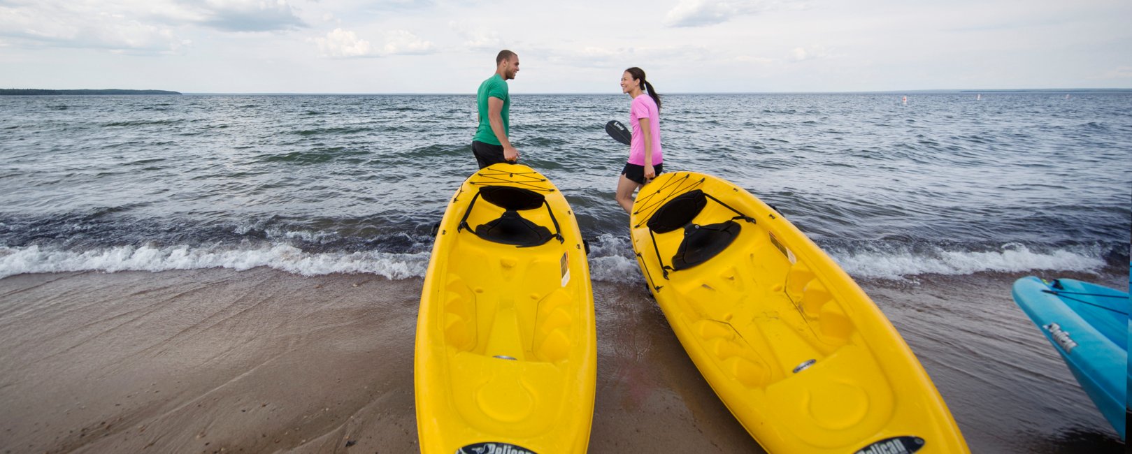Couple taking kayaks out on Kinosoo Beach - Cold Lake