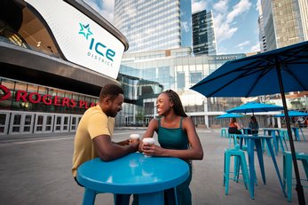 Couple having coffee outside of Rogers Place