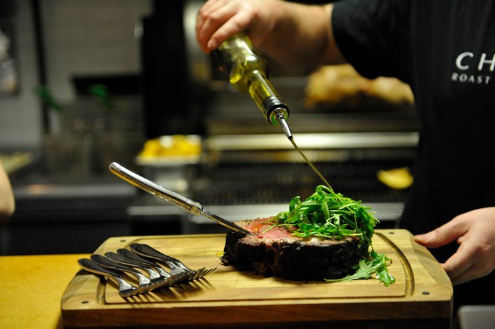 A chef prepares steak at CHARCUT Roast House in Calgary.