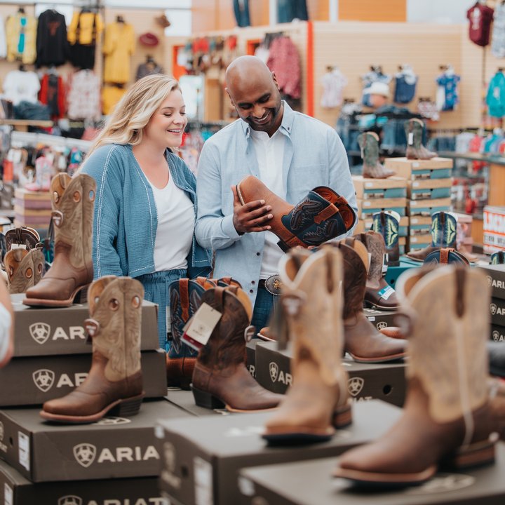 Couple shopping for cowboy boots at Lammles at the Calgary Stampede