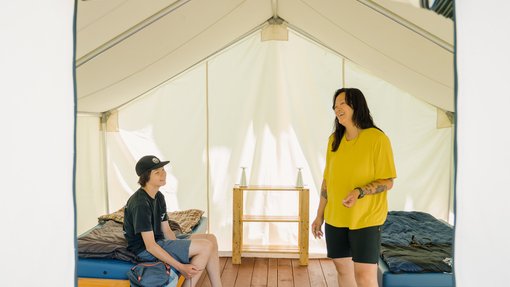 A mother and son inside a tent at Hideaway Adventure Grounds in Smoky Lake.