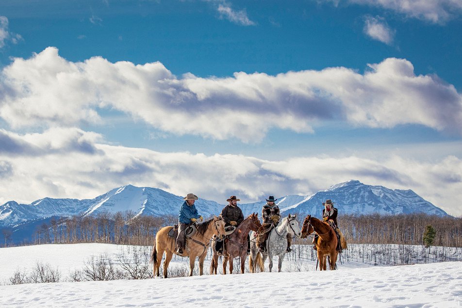 People horseback riding in winter