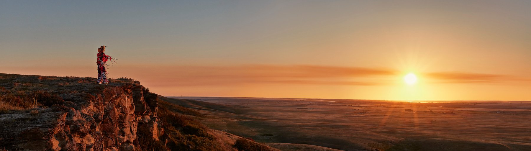 Indigenous man in the Head-Smashed-In Buffalo Jump landscape.