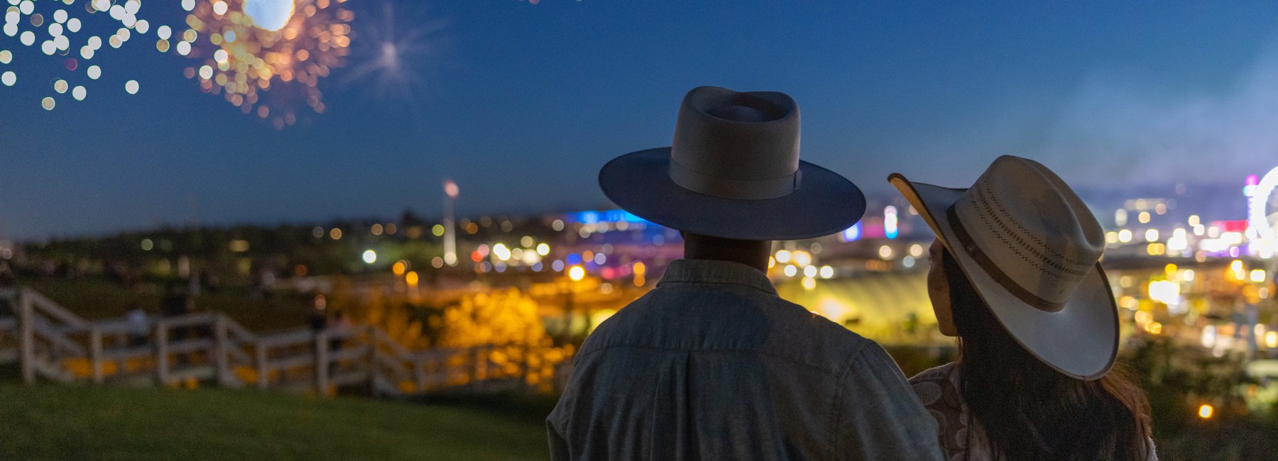A couple watching fireworks at the Calgary Stampede