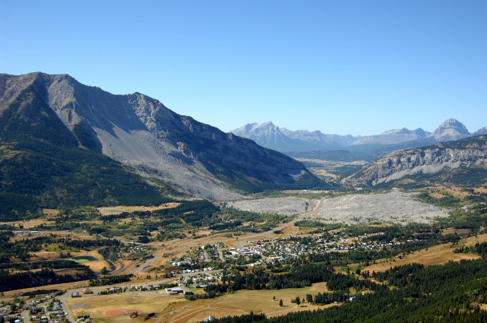 Aerial view of a town with mountain in the background.