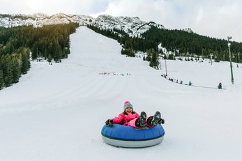 A child tubing down a tube run at Mt. Norquay in Banff National Park.