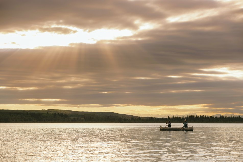 Wide shot of two people canoeing on the Glenmore Reservoir.
