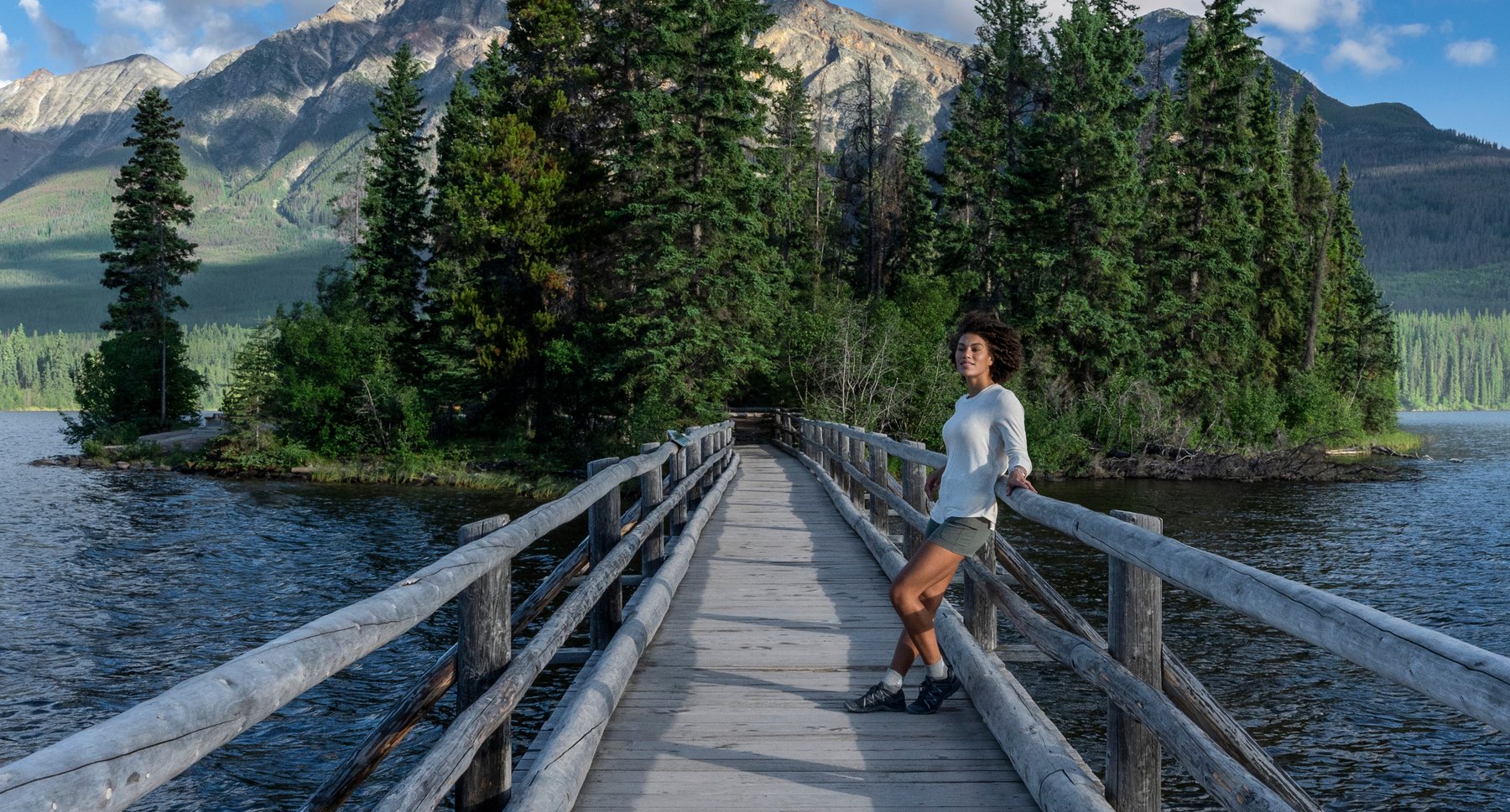 Person standing on bridge at Pyramid Lake in Jasper.