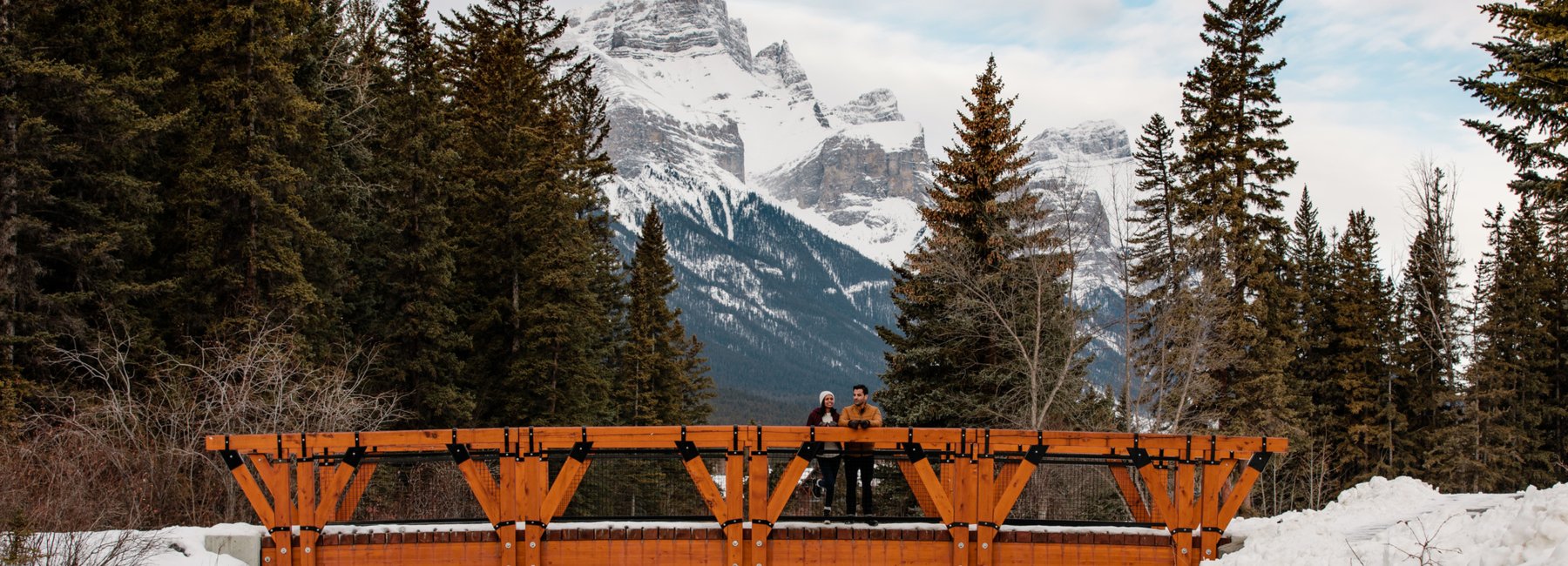 couple on a bridge near the Malcolm Hotel in Canmore Alberta, Rocky Mountains