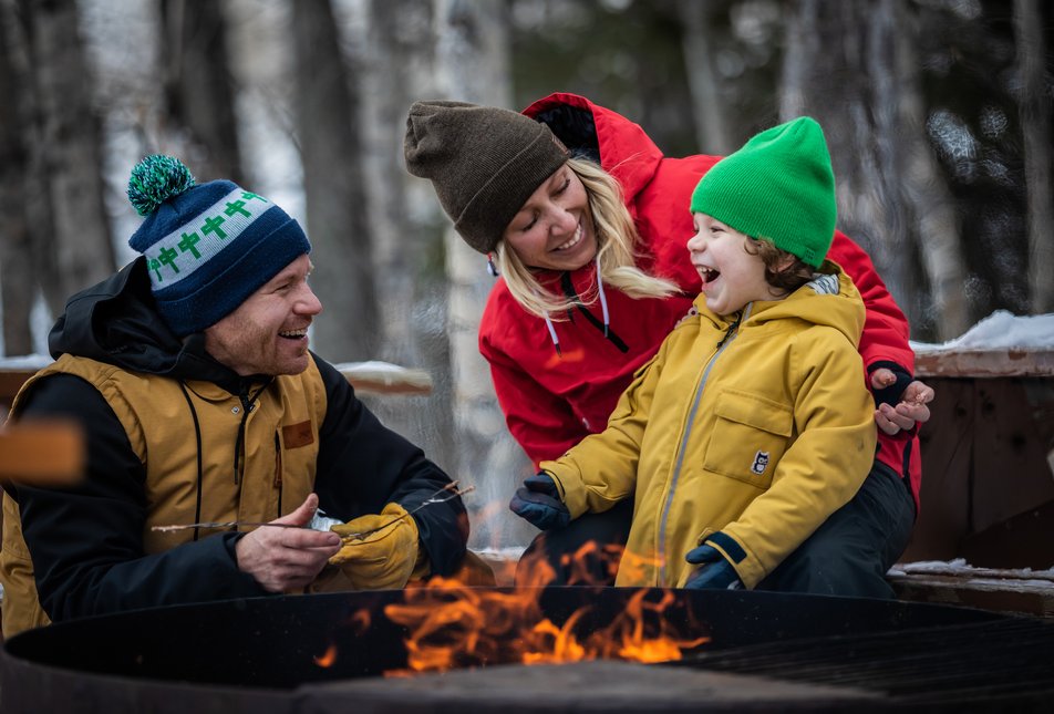 A family roasts marshmallows over a fire pit in Elkwater in Cypress Hills.