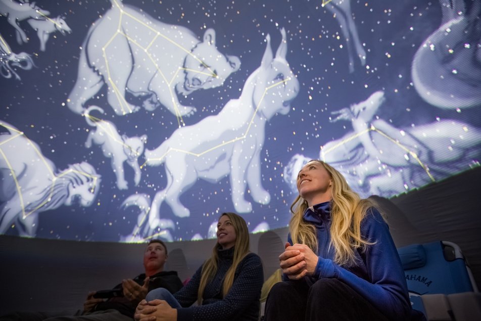 People looking up at the ceiling dome inside Jasper Planetarium