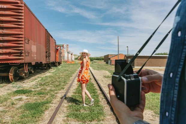 Woman posing for a photo on old train tracks near Medalta in the Historic Clay District in Medicine Hat.