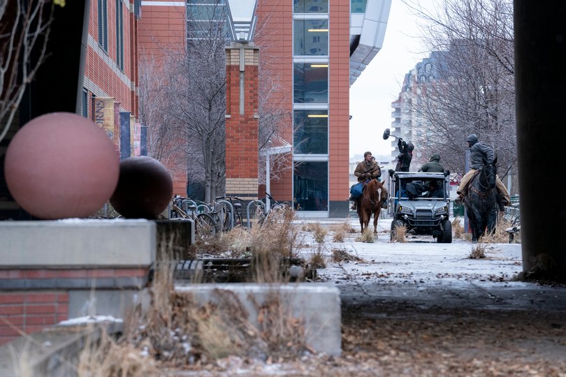 Pedro Pascal and Bella Ramsey on horseback shooting a scene at Calgary’s Southern Alberta Institute of Technology.