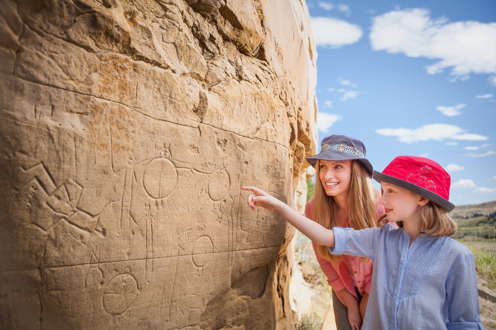 Mother and daughter looking at petroglyphs