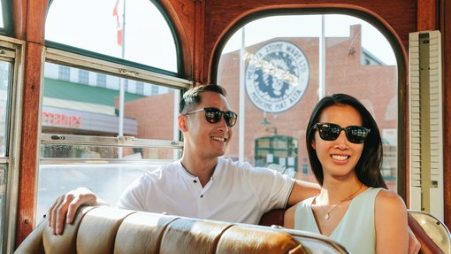 Couple exploring Medicine Hat's historic downtown and riding inside the Medicine Hat Sunshine Trolley.