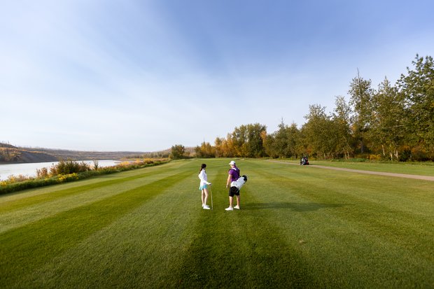Two golfers looking down the green at the Fort McMurray Golf Club.