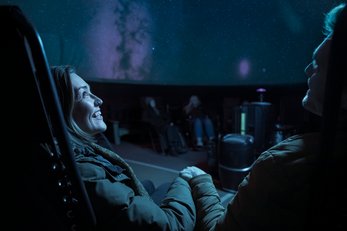 Couple viewing projected sky at the Jasper Planetarium