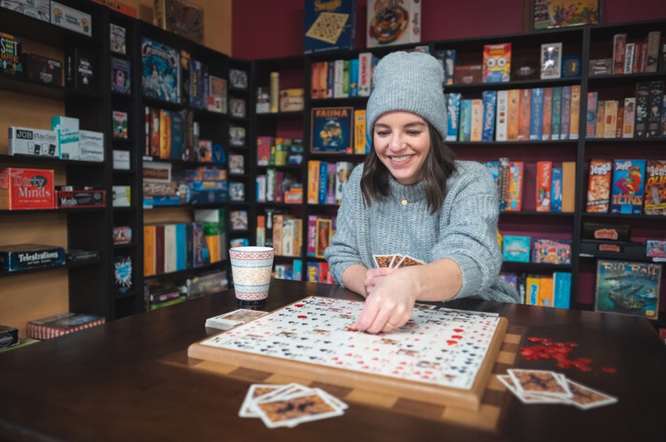 Woman playing a board game at a café.