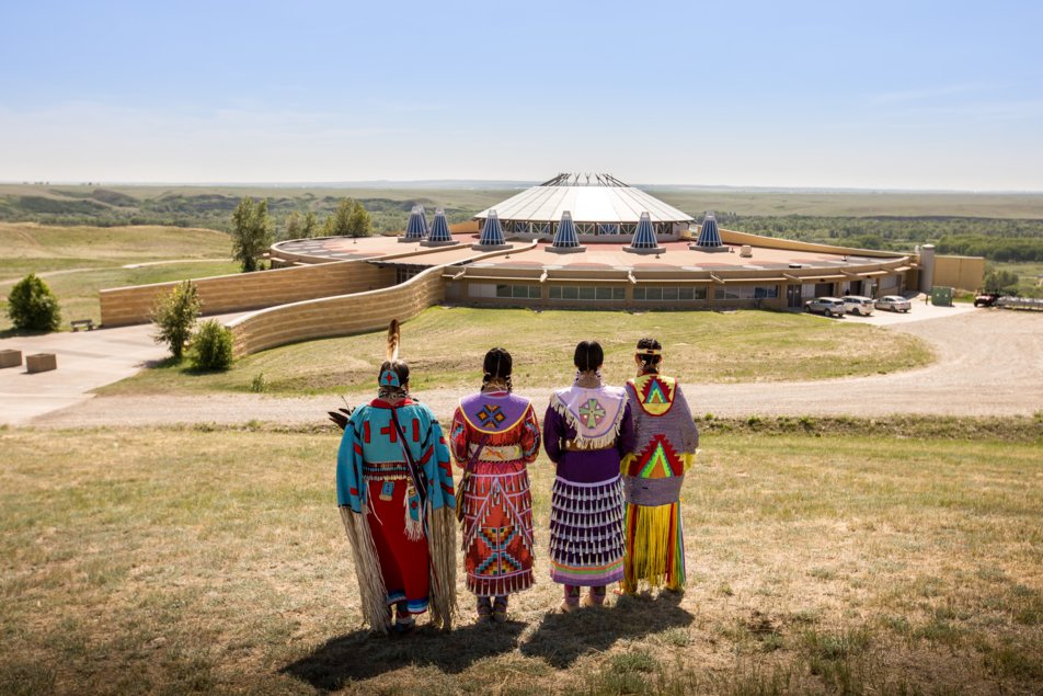 Siksika Blackfoot dancers standing in front of the Blackfoot Crossing Historical Park Interpretive Centre. Canadian Badlands, Alberta.