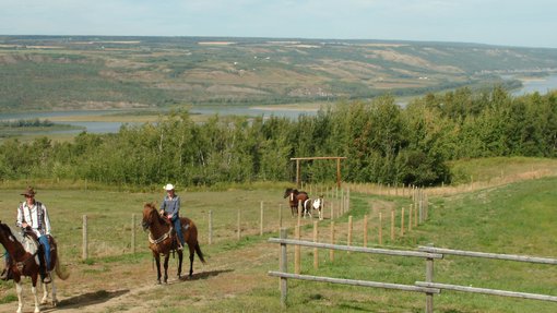 People trail riding on a path near Peace River