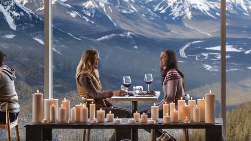 People enjoying a glass of wine overlooking the Bow Valley from Sky Bistro on Sulphur Mountain.
