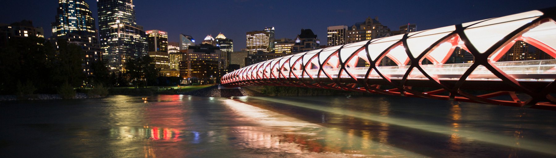 Peace bridge at night with a view of Calgary downtown