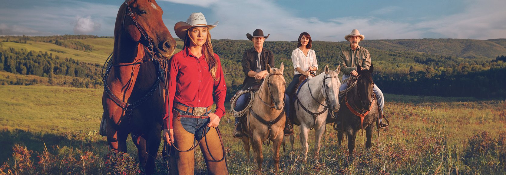 Cast of CBC's Heartland standing in the Foothills of Alberta.