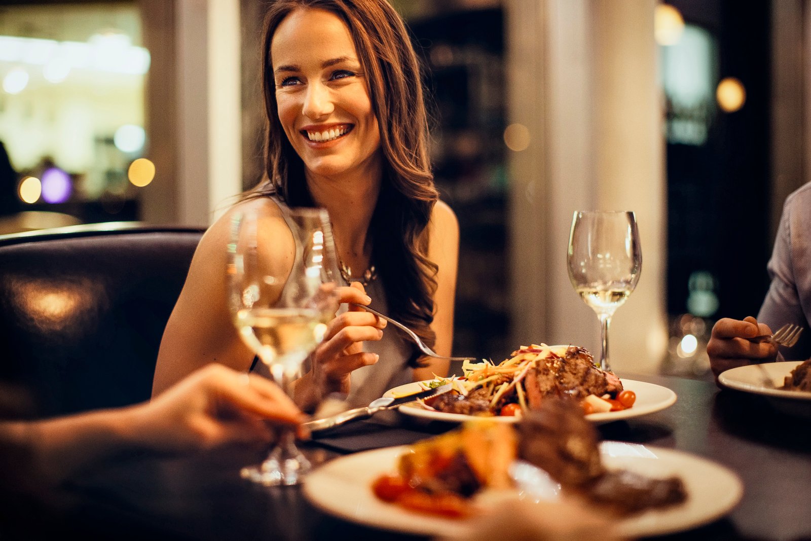 Close-up of a woman dining at Escape Bistro and Wine Bar in Grande Prairie.