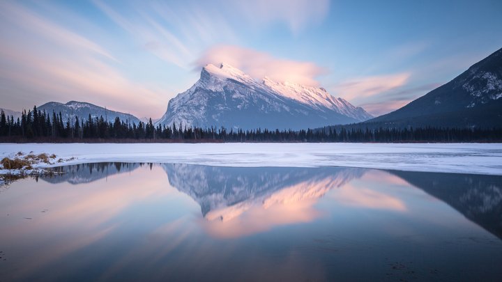 Mount Rundle reflected in the icy Vermilion Lakes in Banff National Park.