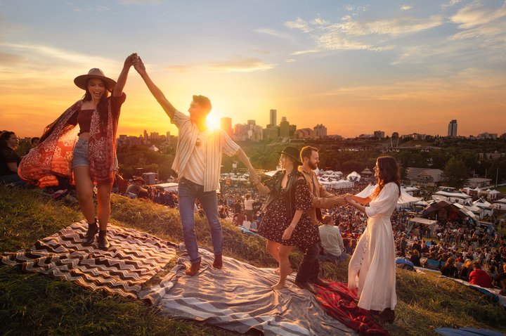 Friends enjoying the Edmonton Folk Festival with downtown Edmonton in the background