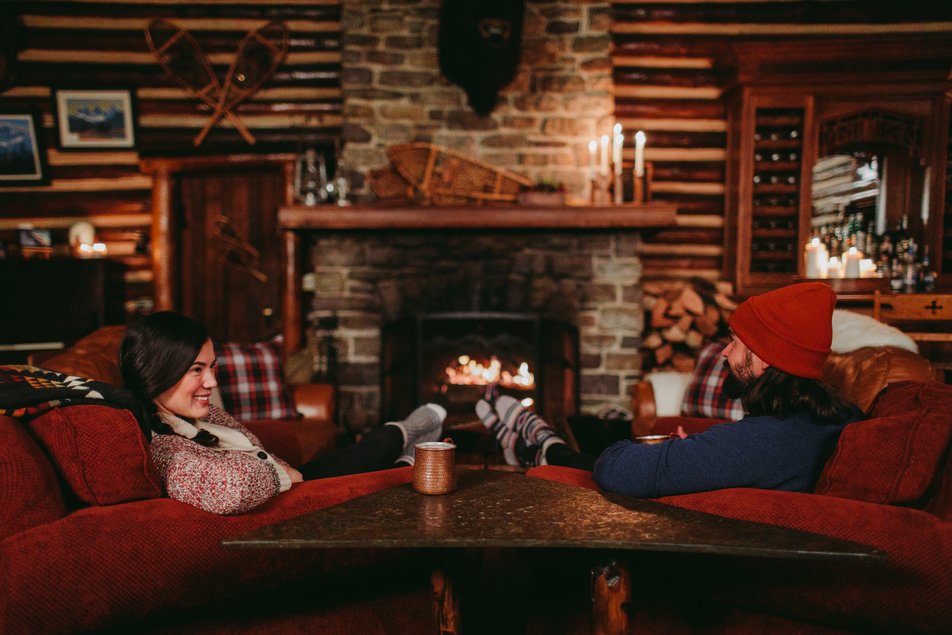 A couple relaxing at Storm Mountain Lodge in Banff.