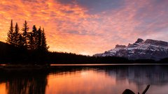 Scenic landscape shot at dusk of lake with mountains in the background