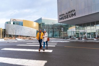 Couple walking down street in front of the Royal Alberta Museum