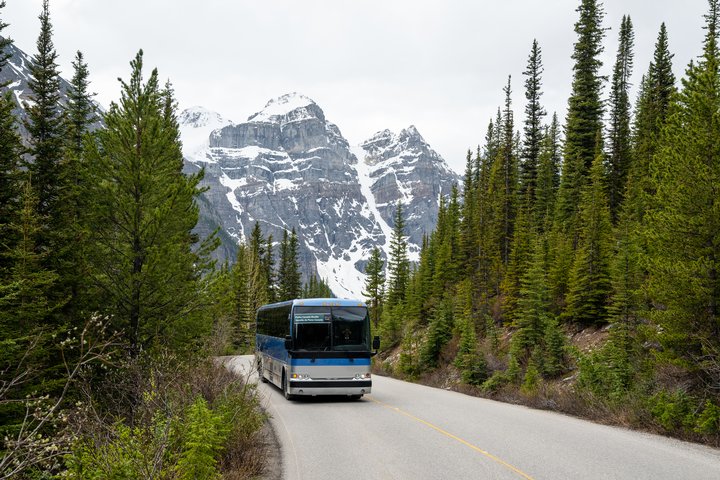 A shuttle bus travels between Lake Louise and Moraine Lake in Banff National Park