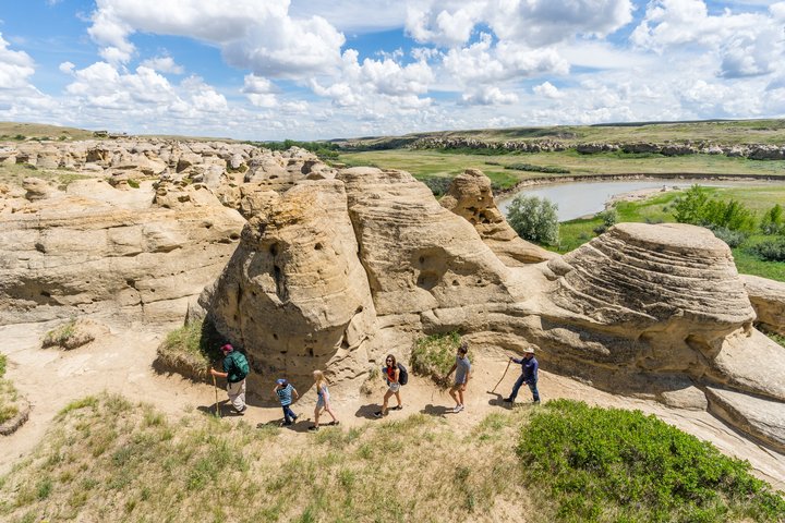 Family hiking on guided tour group at Writing-on-Stone Provincial Park