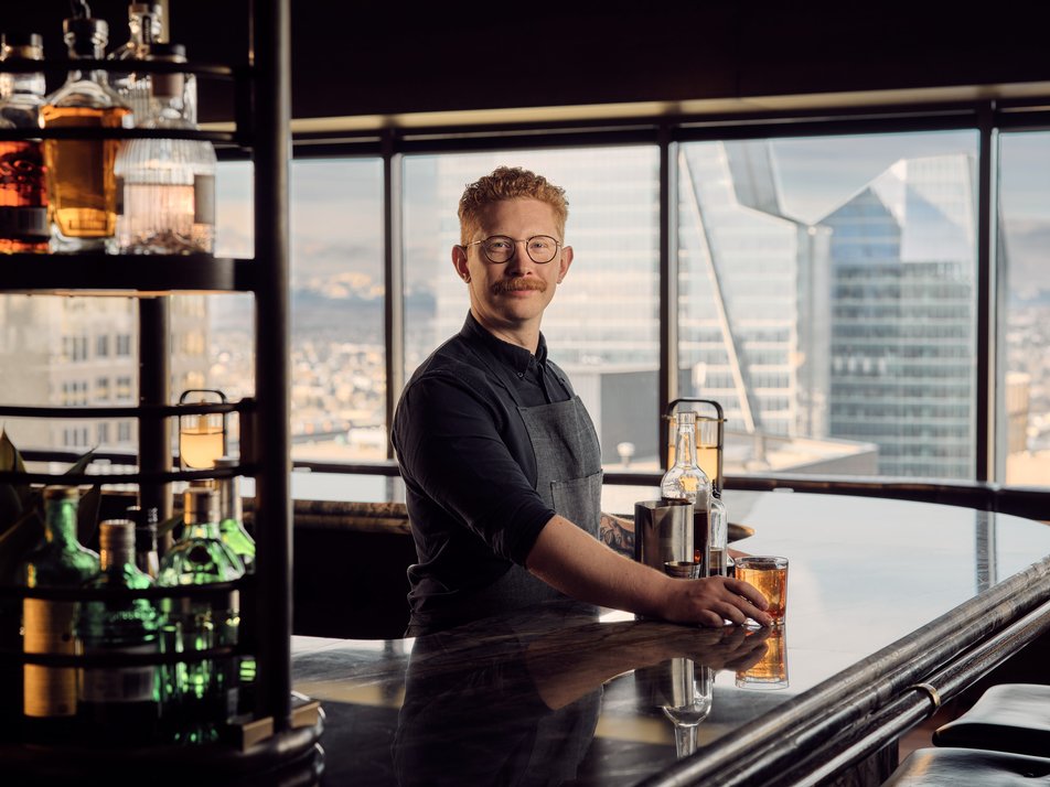 Bartender tends a downtown skyscraper bar