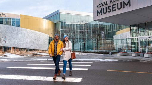 A couple walking outside the Royal Alberta Museum in Edmonton.