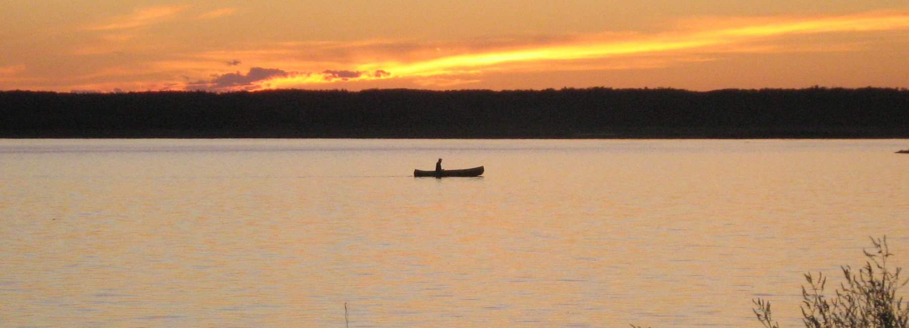 Person canoeing on Miquelon Lake, Midland Provincial Park, Alberta, Canada.