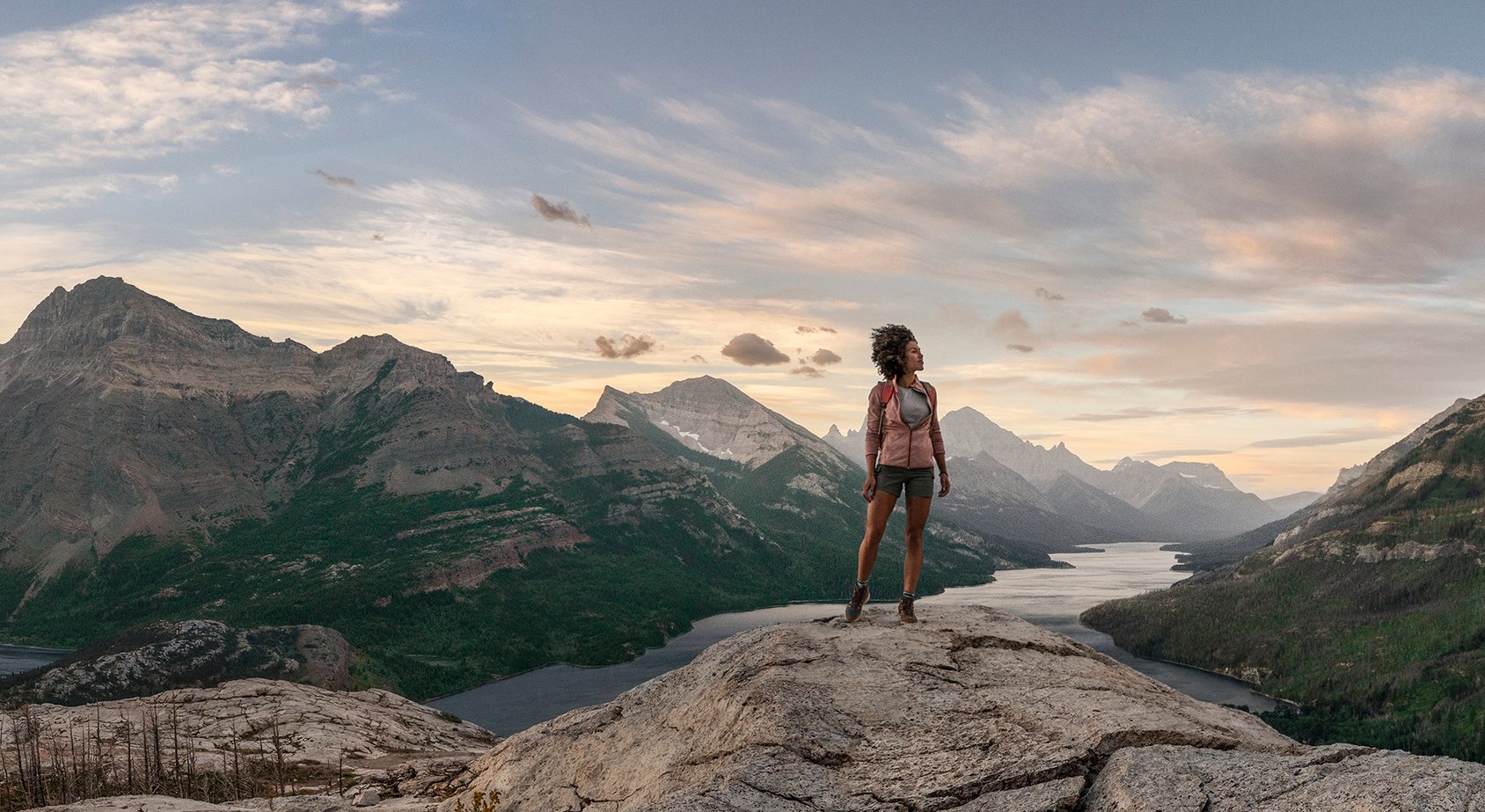 Person standing on top of mountain in Waterton Lakes National Park.